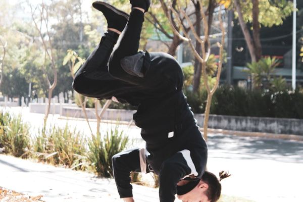 Person performing a controlled yoga movement in a calm, minimalist space.