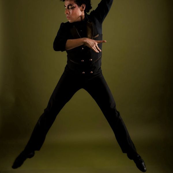 Woman in a dynamic yoga pose, captured mid-movement with a focus on form.